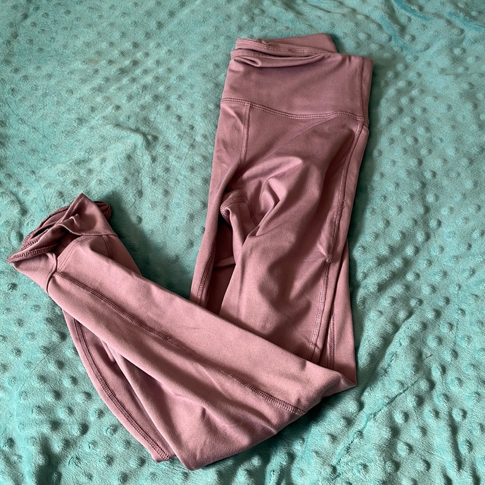 Purple leggings with twist at ankle. Never worn.